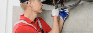 A plumber working on a boiler