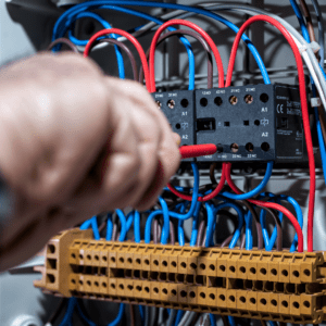 A engineer working on a fuse box