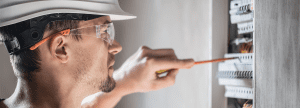 An engineer working on a fuse box
