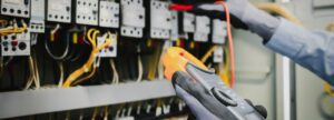 An engineer working on a fuse box