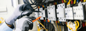 An engineer working on a fuse box