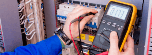 An electrician taking a reading with a multimeter