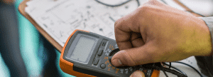 An engineer using a multimeter